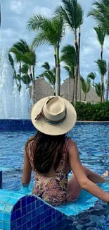 Tropical poolside with a woman in a hat enjoying the serene view.