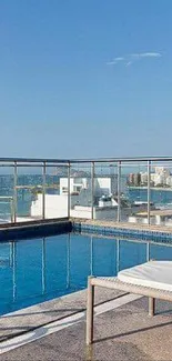 Tropical rooftop pool with blue sky and sea view.