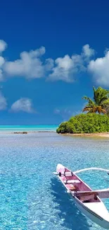 Tropical beach with boat and rich blue ocean.