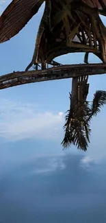 Wooden structure in a blue tropical sky with clouds.