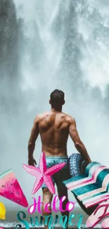 Man with surfboards facing a waterfall, embracing summer spirit.