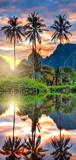 Tropical sunrise with palm trees reflected in calm water.