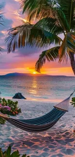 A tropical beach at sunset with palm trees and a hammock.