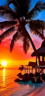 Tropical sunset with a palm tree and beach hut over water.