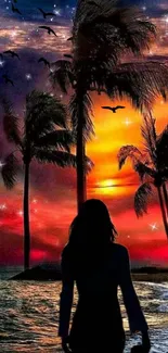 Silhouette by tropical sunset with palm trees and colorful sky.