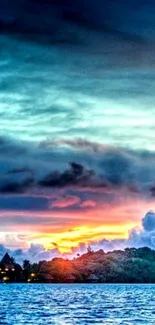 Tropical sunset over ocean with island silhouette.