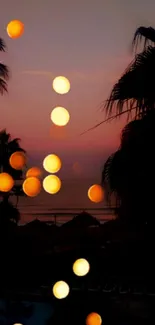 Tropical sunset wallpaper with golden bokeh lights and palm tree silhouettes.