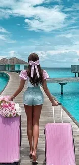 Girl with pink suitcases on tropical boardwalk.