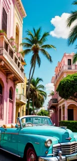 Vintage turquoise car on a tropical street with palm trees and colorful buildings.