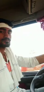 Trucker in vehicle interior with warm colors, capturing travel adventure.