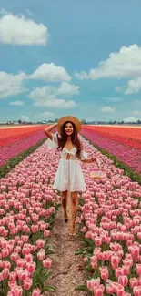 Woman in white dress walking through vibrant tulip field under blue sky.