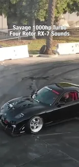 Turbocharged black RX-7 drifting on a race track with smoke clouds.