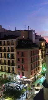 Twilight view of a city skyline with vibrant evening lights.