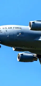 U.S. Air Force jet flies against blue sky.