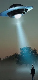 Mysterious UFO shines light on figure in dark forest wallpaper.