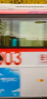 Blurry city bus and umbrella in motion.