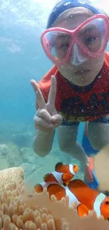 Underwater view with snorkeler and clownfish in vibrant coral reef.