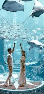 Couple gazing at sea life in an aquarium setting, surrounded by serene blue hues.