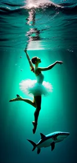 Graceful ballerina dances underwater with a shark in a turquoise glow.