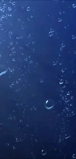 Dark blue underwater scene with bubbles.