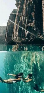 Couple swimming under a scenic cliff in turquoise waters.