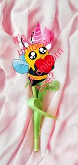 Whimsical unicorn bee on a flower with pink background.