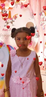 Girl in pink dress at unicorn-themed birthday party with hearts.