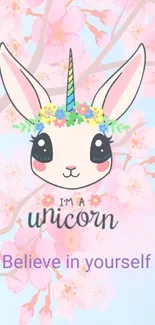 Cute unicorn wallpaper with pastel cherry blossoms and inspiring text.