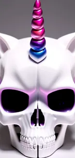 A white skull with a vibrant unicorn horn and purple accents.