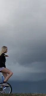 Woman on unicycle beneath dramatic cloudy sky, evokes balance and serenity.