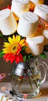 Floral and marshmallow arrangement in a glass vase.