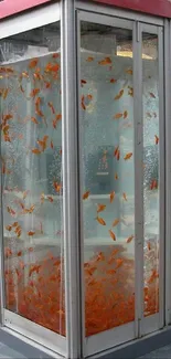 Phone booth filled with goldfish in an urban setting, creating a unique art display.