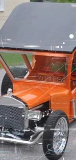 Orange hot rod car parked on a street with unique design and style.