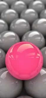 Vibrant pink sphere among grey spheres mobile wallpaper.