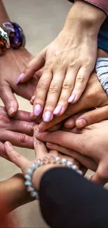 A group of diverse hands joined together symbolizing unity.