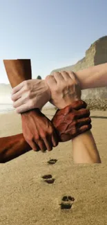 Diverse hands united on a sandy beach with a coastal backdrop.