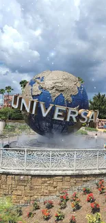 Universal globe at theme park with blue sky background.