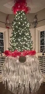 Upside down Christmas tree in a cozy room with festive lights.