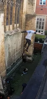 Person performing a parkour jump from a historic building ledge.