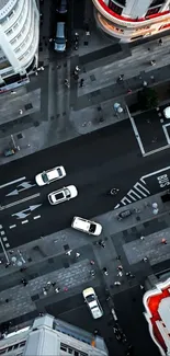 Aerial view of a busy city street with cars and pedestrians.