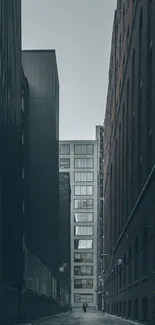 A person walks through a narrow city alleyway between tall buildings.