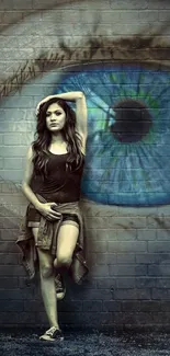 Person standing by a vibrant eye mural on a brick wall, showcasing urban art.