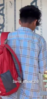 Young traveler with red backpack in urban background.