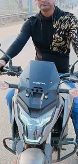Man riding a motorcycle on a city road.