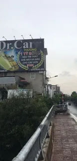 City street with urban billboard and cloudy skies.