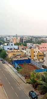 Aerial view of a vibrant city street with colorful buildings and greenery.