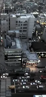 Aerial view of bustling city streets at night with illuminated buildings.