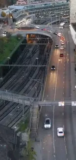 Aerial view of city road with cars and rail tracks.