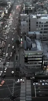 A bustling cityscape with cars in traffic at dusk.