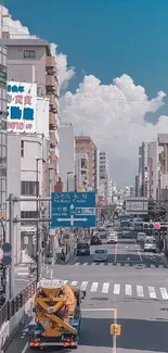 City street with blue sky and clouds, showcasing urban life.